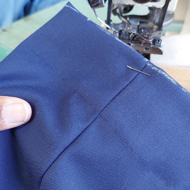Navy sleeve hem on the sewing machine
